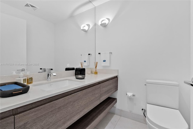 bathroom featuring tile patterned floors, vanity, and toilet