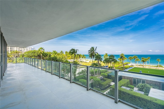 balcony with a beach view and a water view