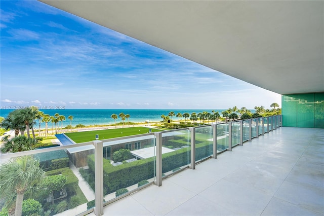 balcony with a water view and a beach view