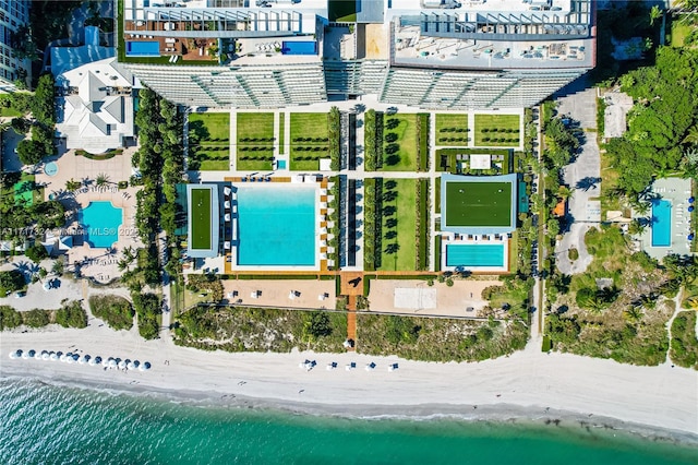 birds eye view of property featuring a beach view and a water view