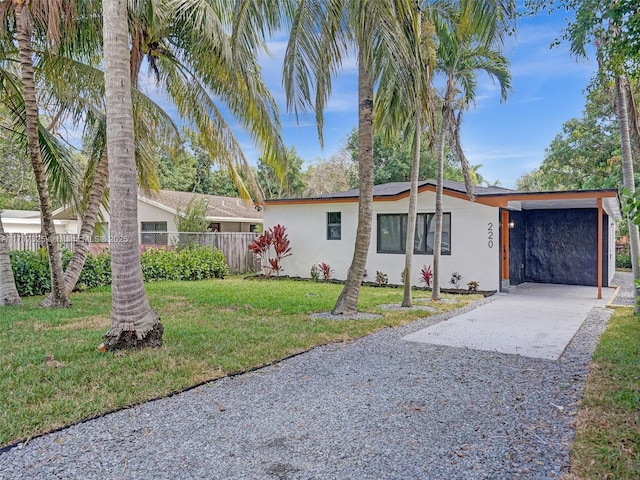 ranch-style home with a front yard and a carport