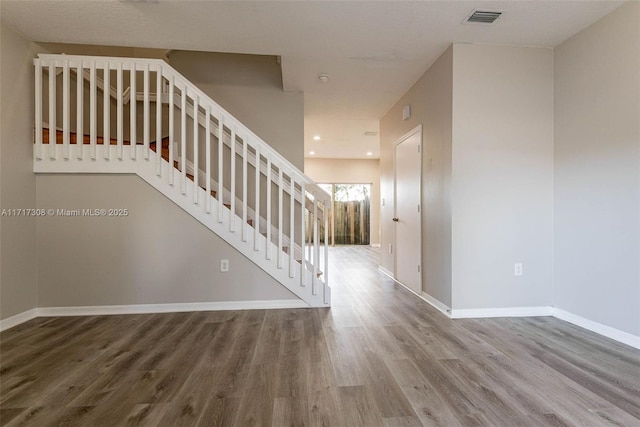 stairway featuring hardwood / wood-style flooring