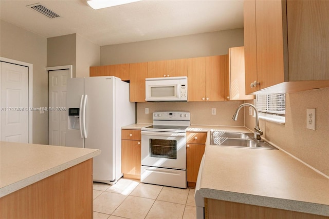 kitchen featuring light tile patterned floors, white appliances, light brown cabinetry, and sink