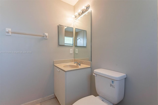 bathroom with tile patterned flooring, vanity, and toilet