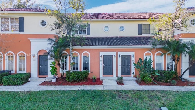 mediterranean / spanish home featuring a front lawn