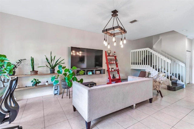 living room featuring a notable chandelier and light tile patterned flooring