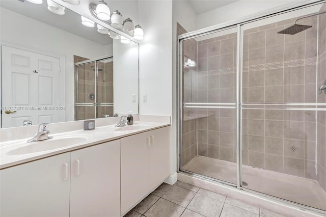 bathroom featuring tile patterned flooring, vanity, and a shower with shower door