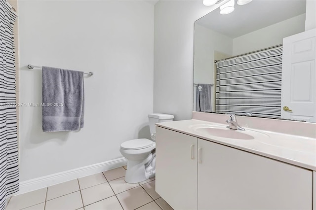 bathroom featuring tile patterned floors, vanity, and toilet