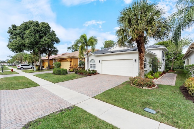 single story home featuring a garage and a front lawn