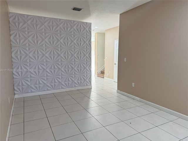 spare room featuring light tile patterned floors