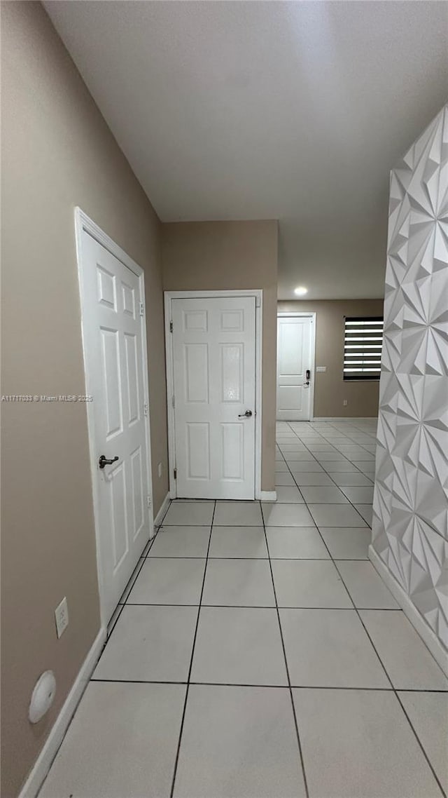 corridor featuring light tile patterned floors