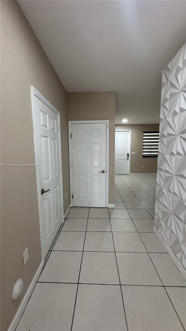 hallway featuring light tile patterned floors