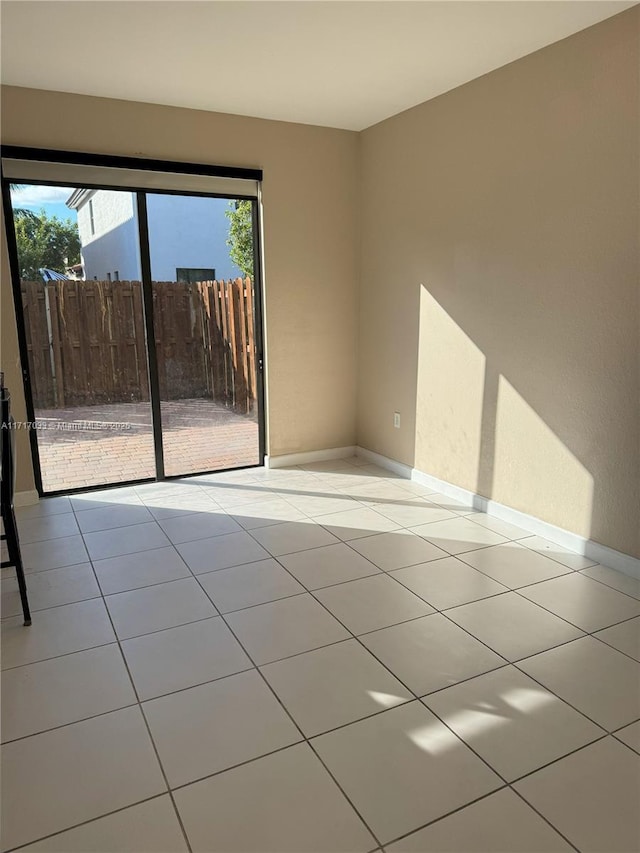 spare room featuring light tile patterned floors