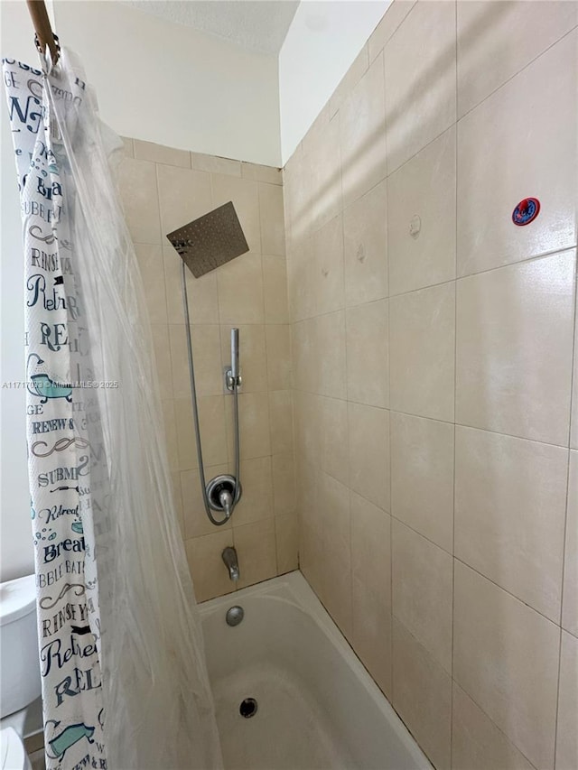 bathroom with toilet and shower / tub combo with curtain