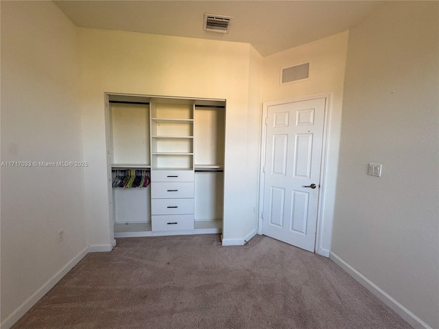 unfurnished bedroom featuring carpet and a closet