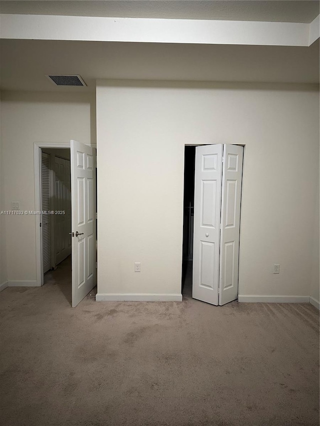 unfurnished bedroom featuring light colored carpet