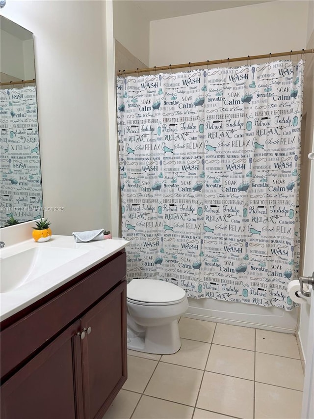 full bathroom featuring tile patterned floors, shower / bath combination with curtain, toilet, and vanity