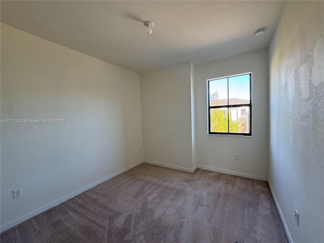 unfurnished room with light carpet