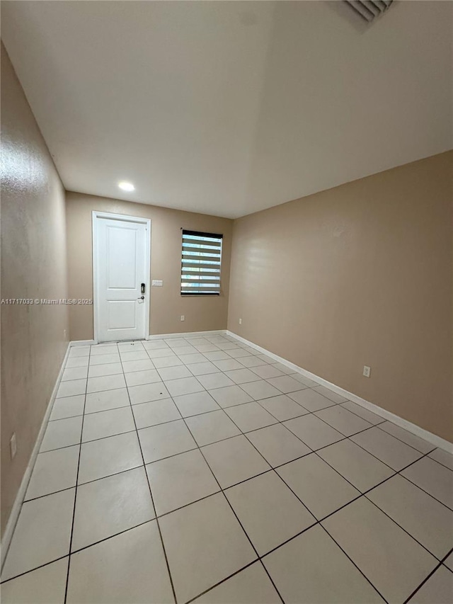 spare room featuring light tile patterned floors