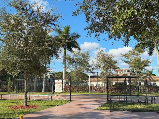 view of home's community featuring basketball hoop