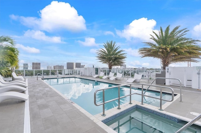 view of pool featuring a community hot tub and a patio area