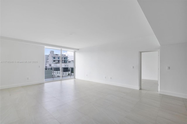 spare room featuring a wall of windows