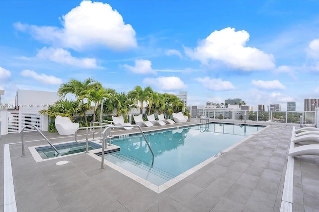 view of swimming pool featuring a patio area and a community hot tub