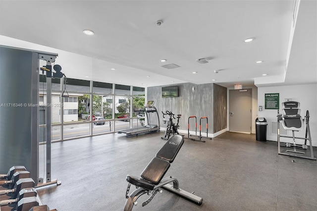 gym with a wall of windows