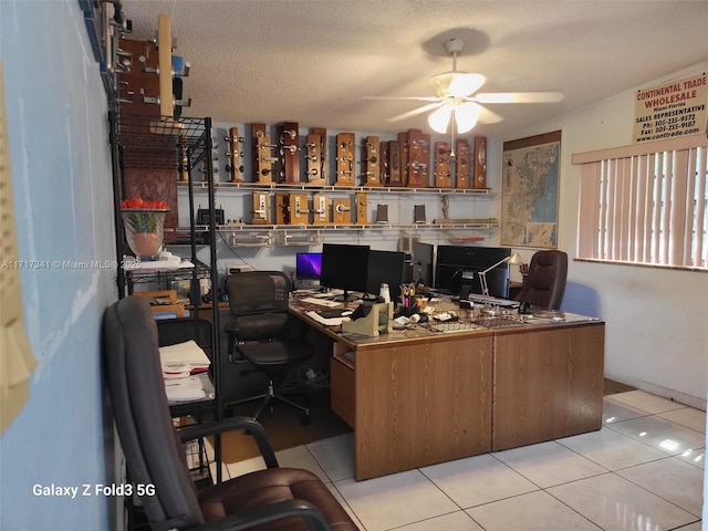 tiled home office with a textured ceiling and ceiling fan