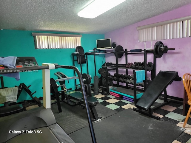 workout area featuring a textured ceiling