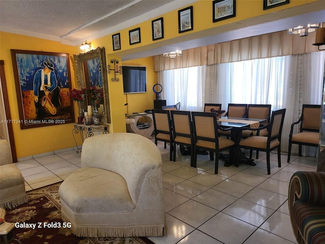 dining space with tile patterned floors and a textured ceiling