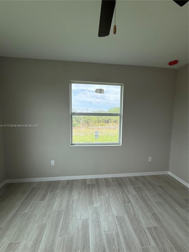 empty room with light hardwood / wood-style flooring and ceiling fan