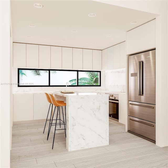 330 76th St Unit 4, Miami Beach, FL 33141 - kitchen with white cabinets, stainless steel appliances, a kitchen breakfast bar, and modern cabinets