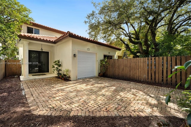 rear view of property featuring a garage