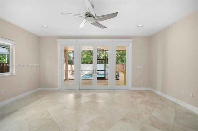 spare room featuring ceiling fan, a healthy amount of sunlight, and french doors