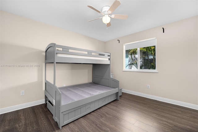 unfurnished bedroom with ceiling fan and dark hardwood / wood-style flooring