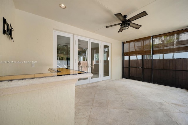 interior space with ceiling fan