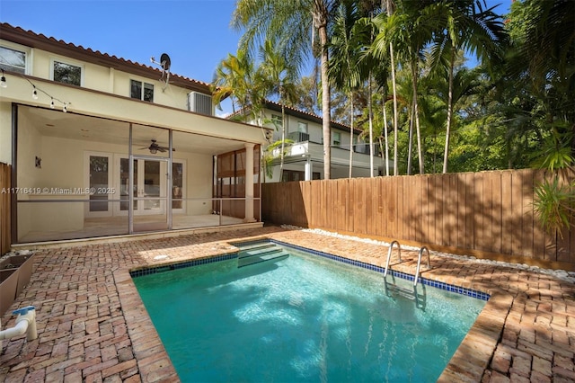 view of swimming pool with ceiling fan and a patio area