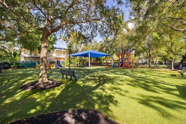 view of property's community with a playground and a lawn