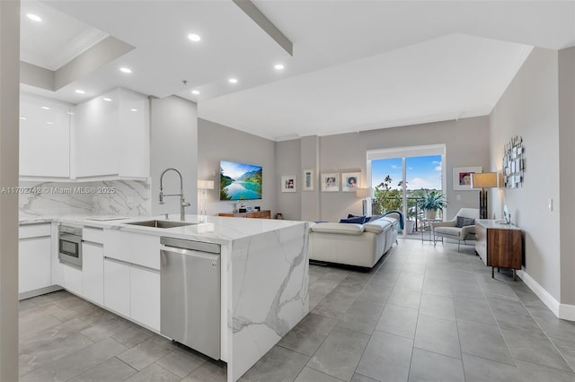 kitchen with sink, dishwasher, white cabinetry, kitchen peninsula, and oven