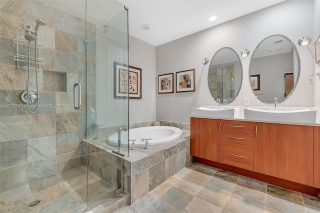 bathroom with vanity and independent shower and bath