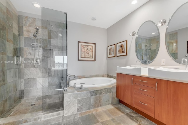 bathroom featuring separate shower and tub and vanity