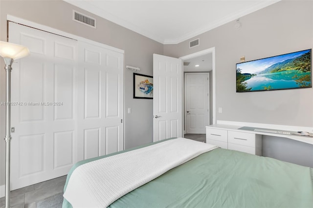 bedroom with a closet and crown molding