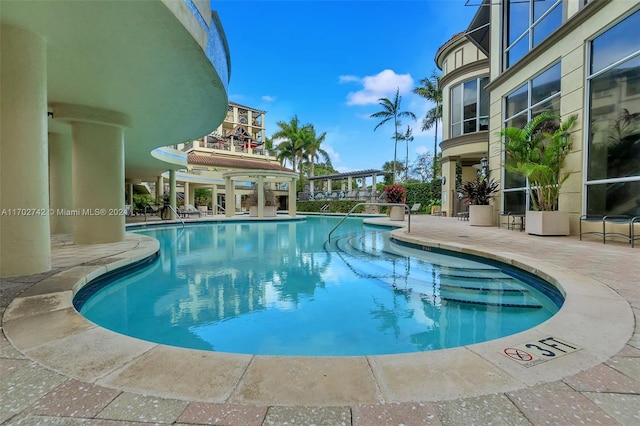 view of swimming pool featuring a patio area