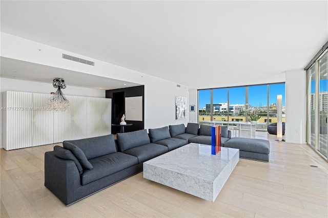 living room with light hardwood / wood-style floors and expansive windows