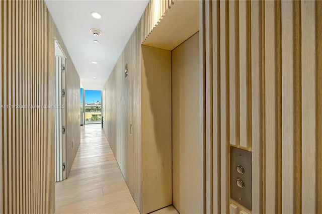 corridor with light hardwood / wood-style flooring