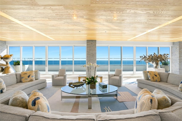 sunroom featuring a water view and wooden ceiling