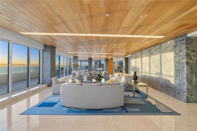 living room with a water view and wood ceiling