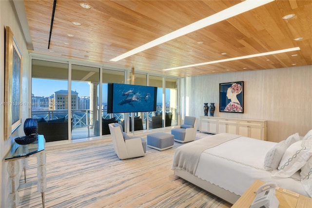 bedroom with access to exterior, wood ceiling, and a wall of windows