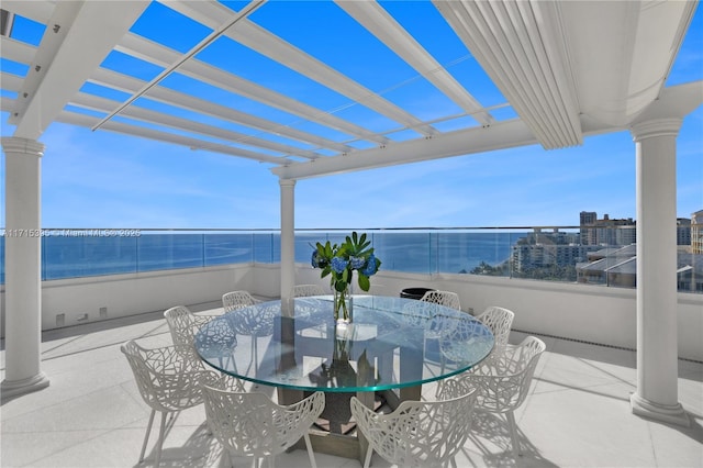 view of patio / terrace featuring a water view and a pergola